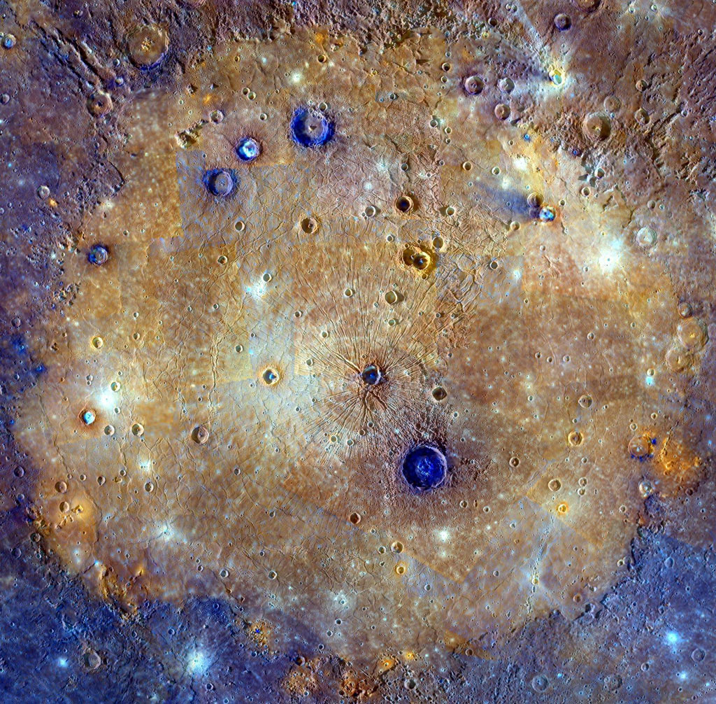 Cratered surface of Mercury's Caloris Basin in enchanced colors of blue and orange.