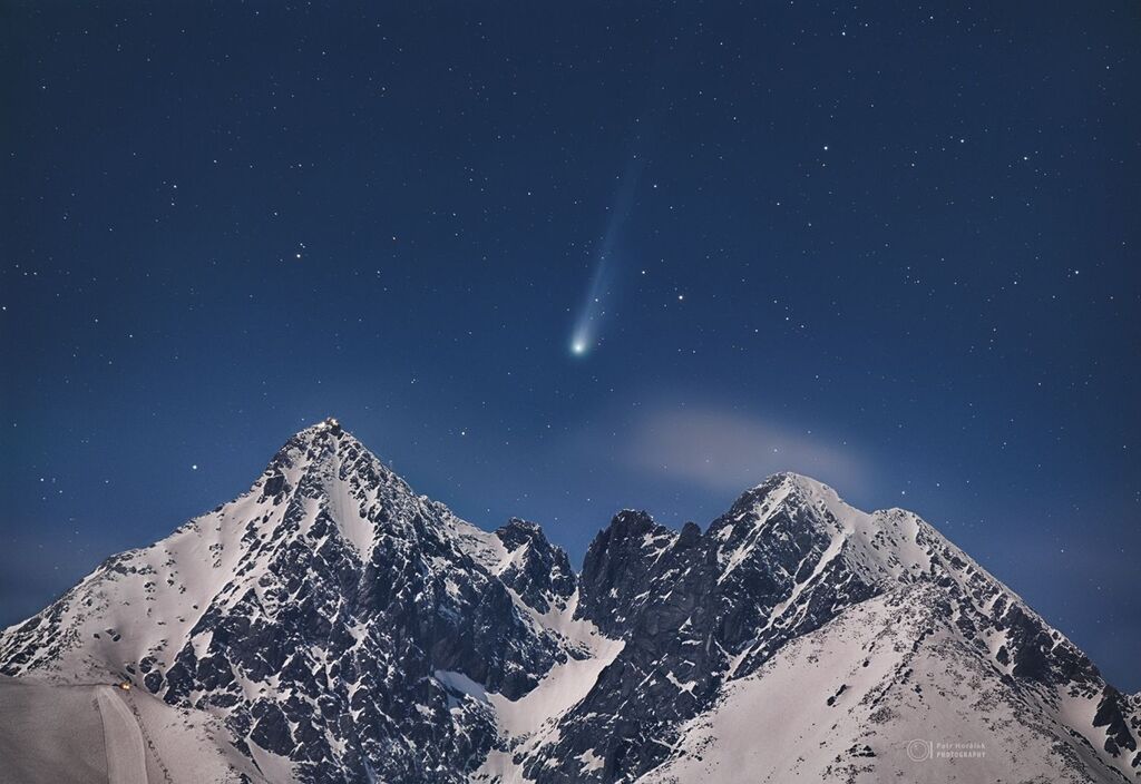 Comet 12p Pons above a snowy mountain range at nightfall