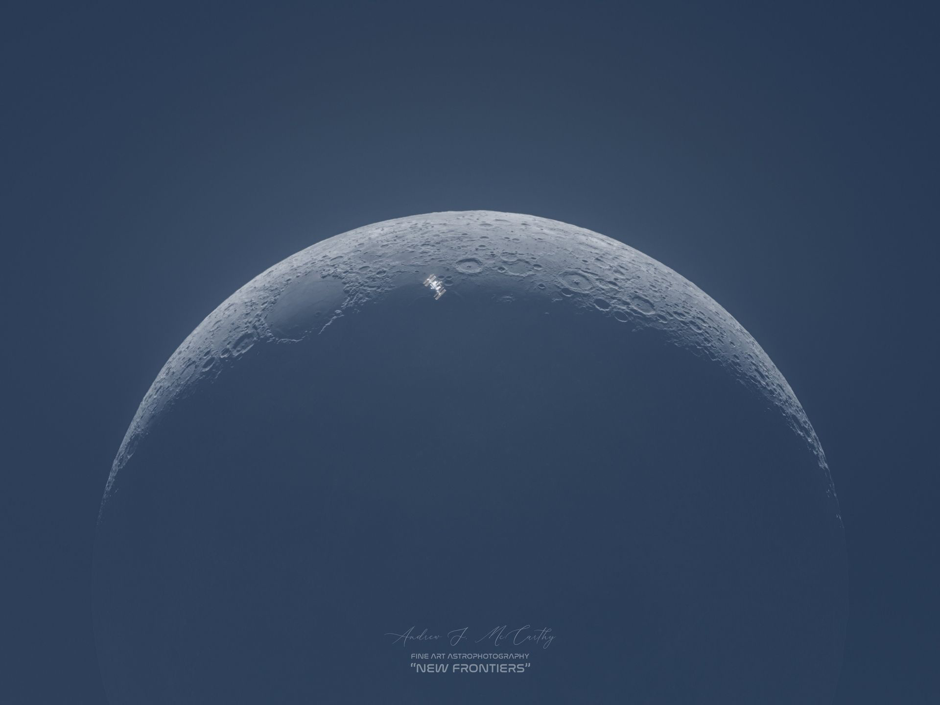 the ISS captured right in the center of the crescent moon