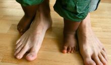 image of a child's feet with an adult's feet