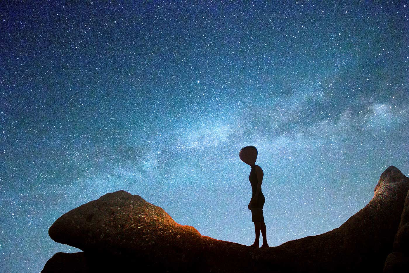 Alien figure looking at the sky