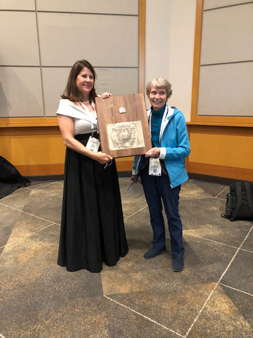 Dr. Janice Bishop being presented her award plaque.