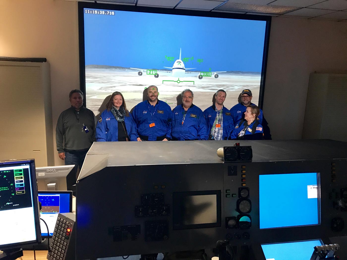 Ambassadors posing in front of a screen of SOFIA