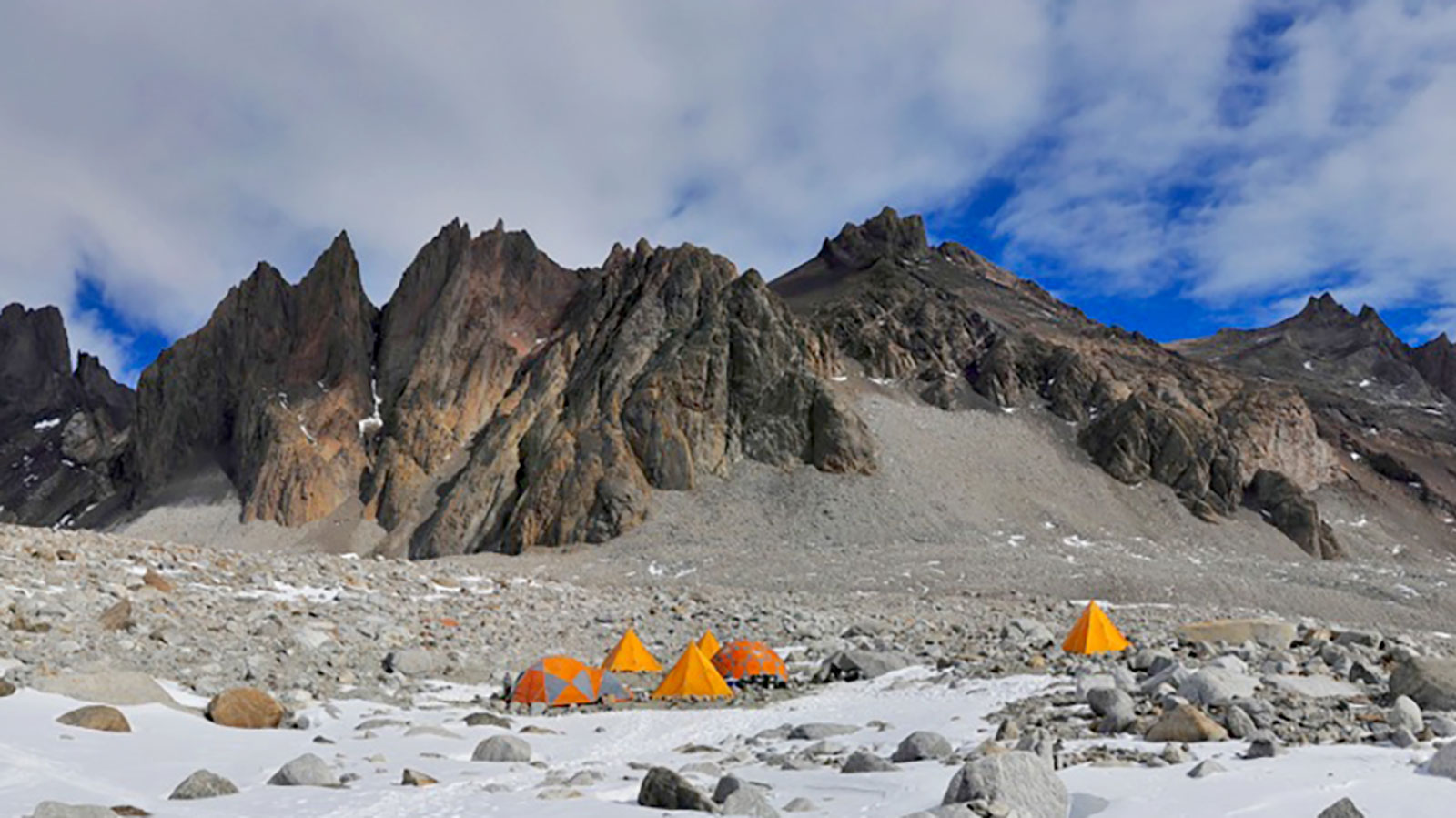 camp nestled between the rocks and snow