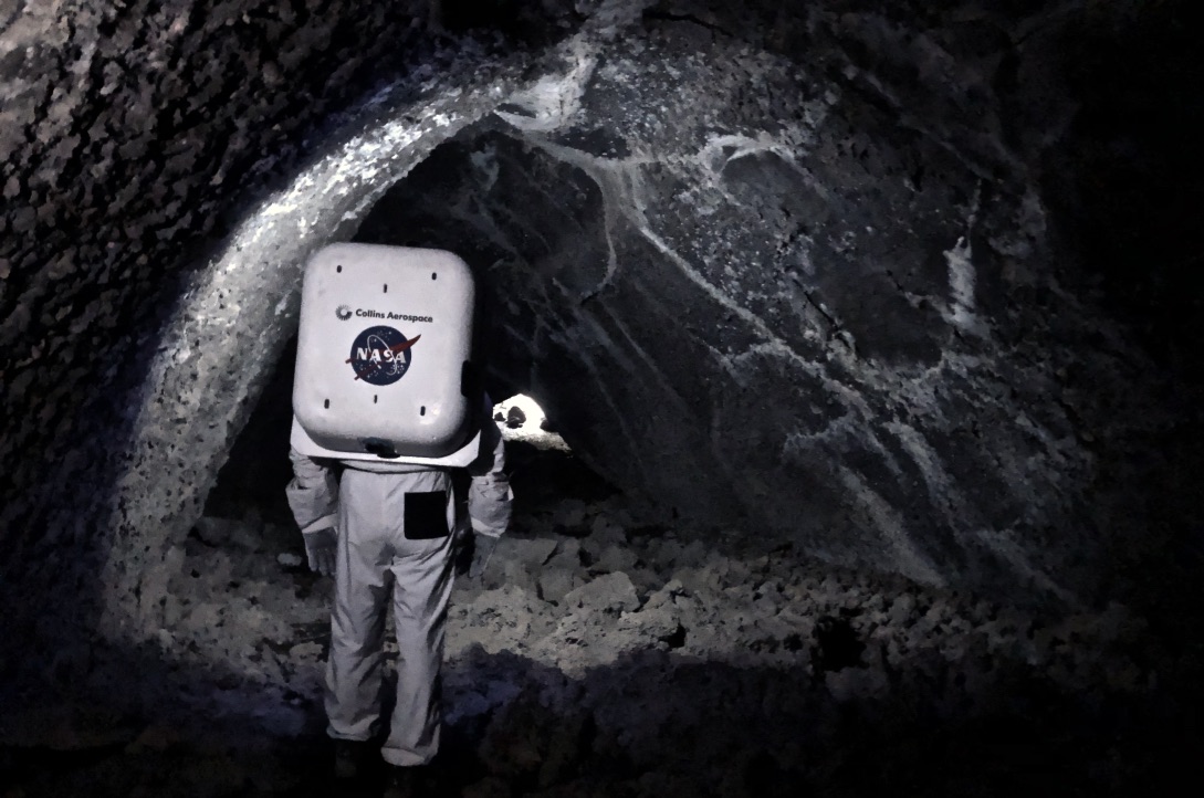 Cave exploration in the spacesuit from the behind the suit