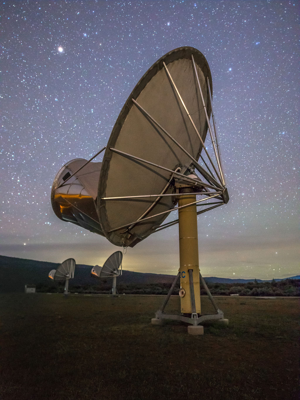 Image of the back of an ATA Dish under the night's starry sky