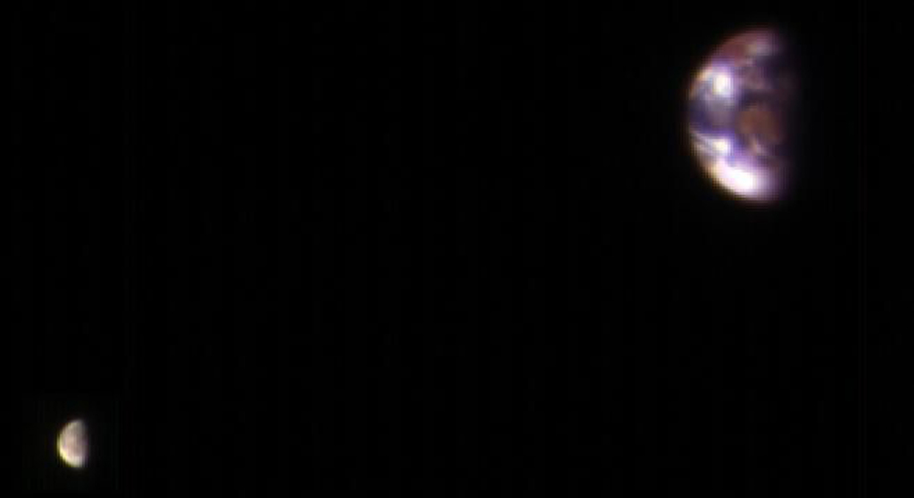 blurry distant image of the earth and moon