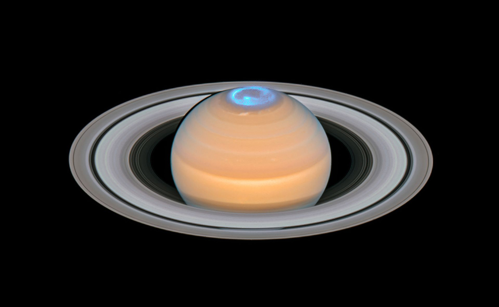 Image of Saturn and its rings with a bright blue light ring emitting from the top of the planet
