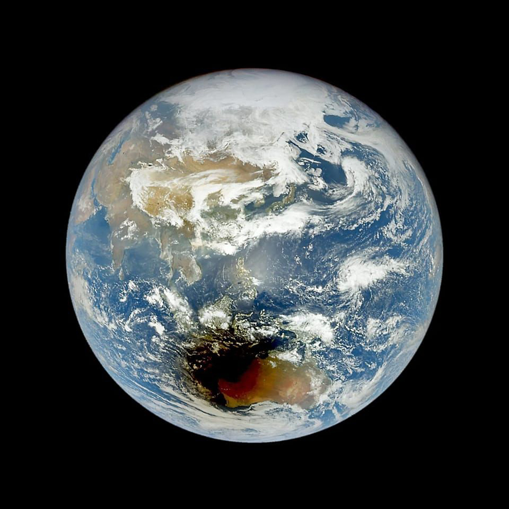 Space image of Earth with a dark shadow covering the regions around Australia