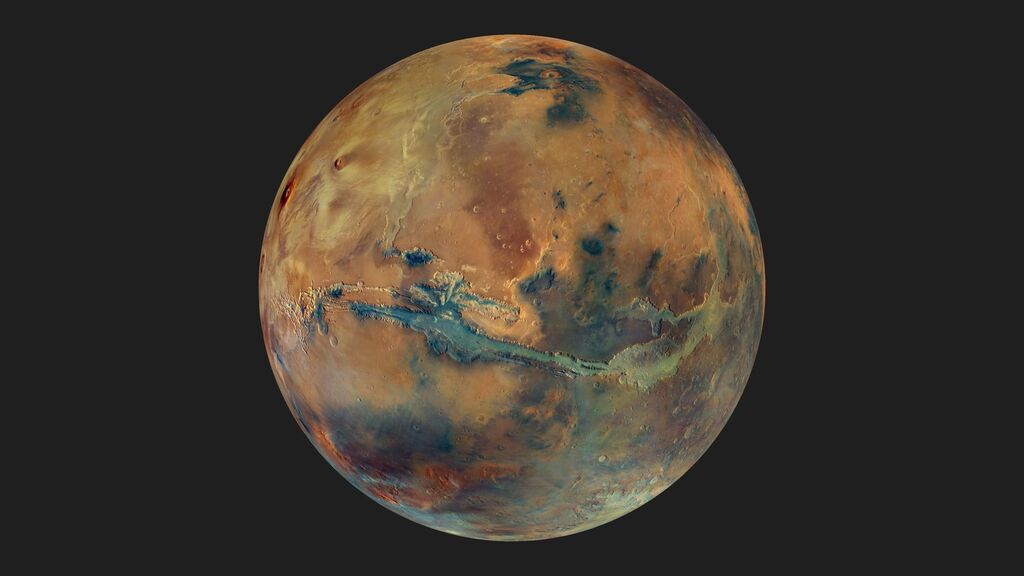 Image of the red planet with some blue and green hues
