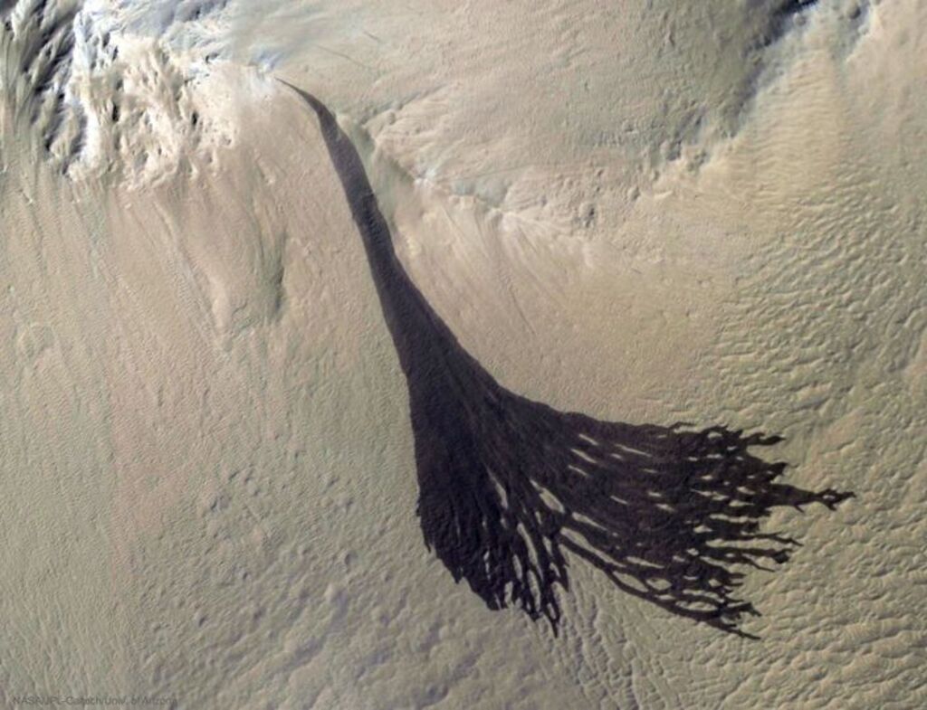 Dark shadow streaks covering the martian hill side