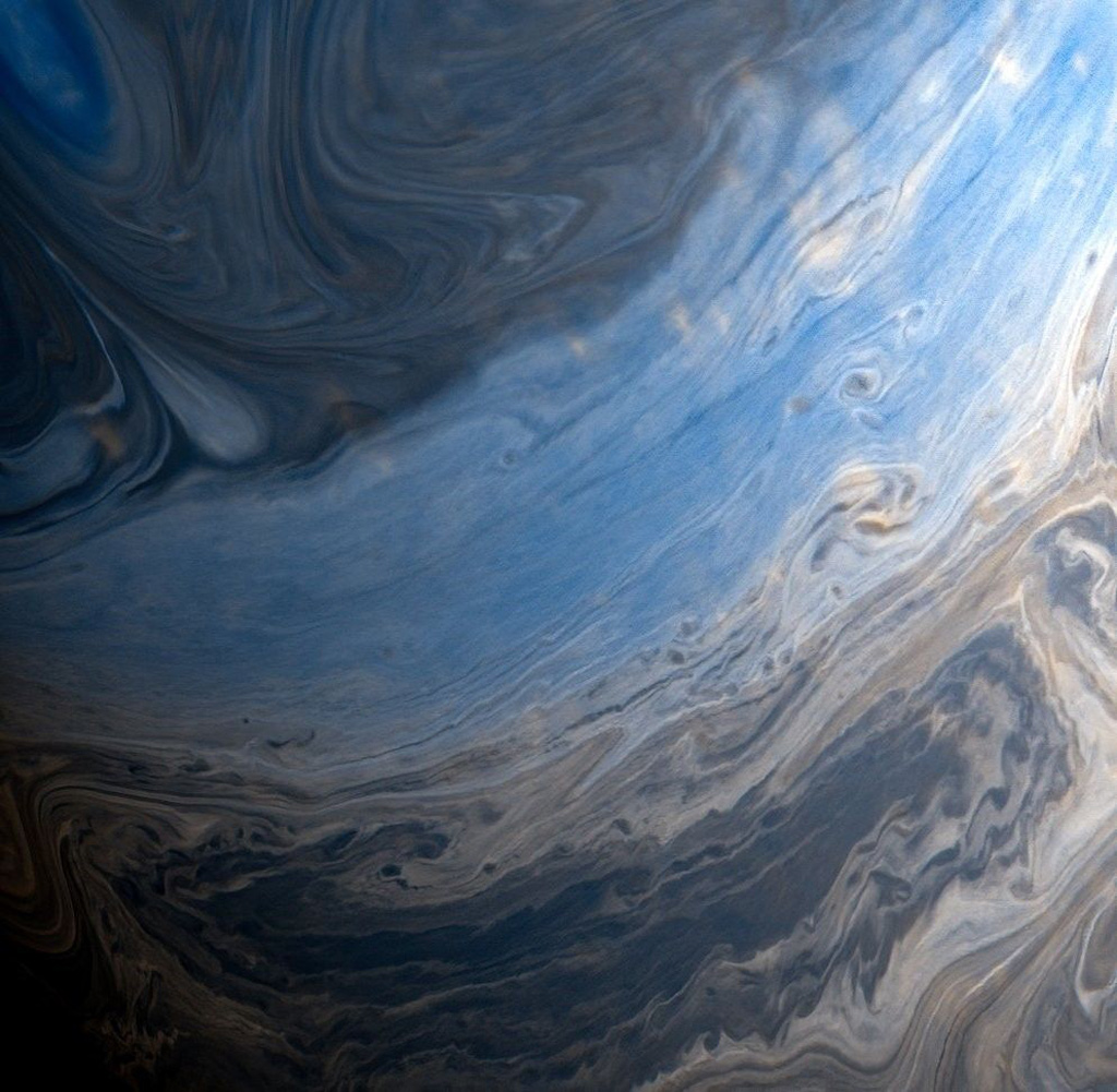 close up of the gray and blue swirls on the surface of Saturn