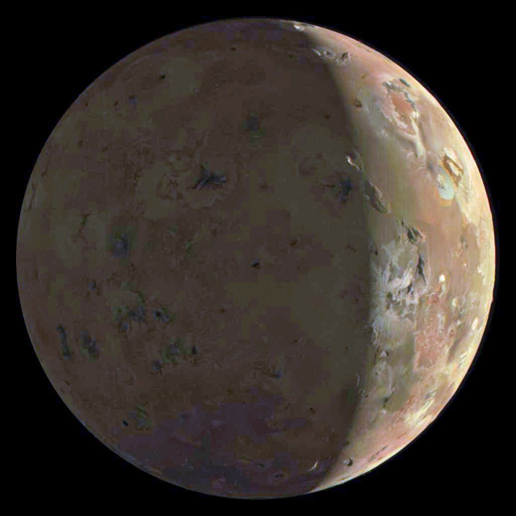 image of the beige moon Io with a solar shadow