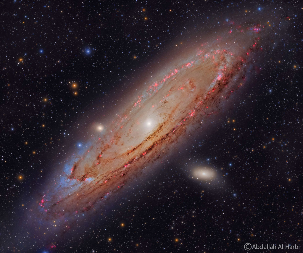 Image of the Andromeda galaxy swirl surrounded by tiny bursts of lights