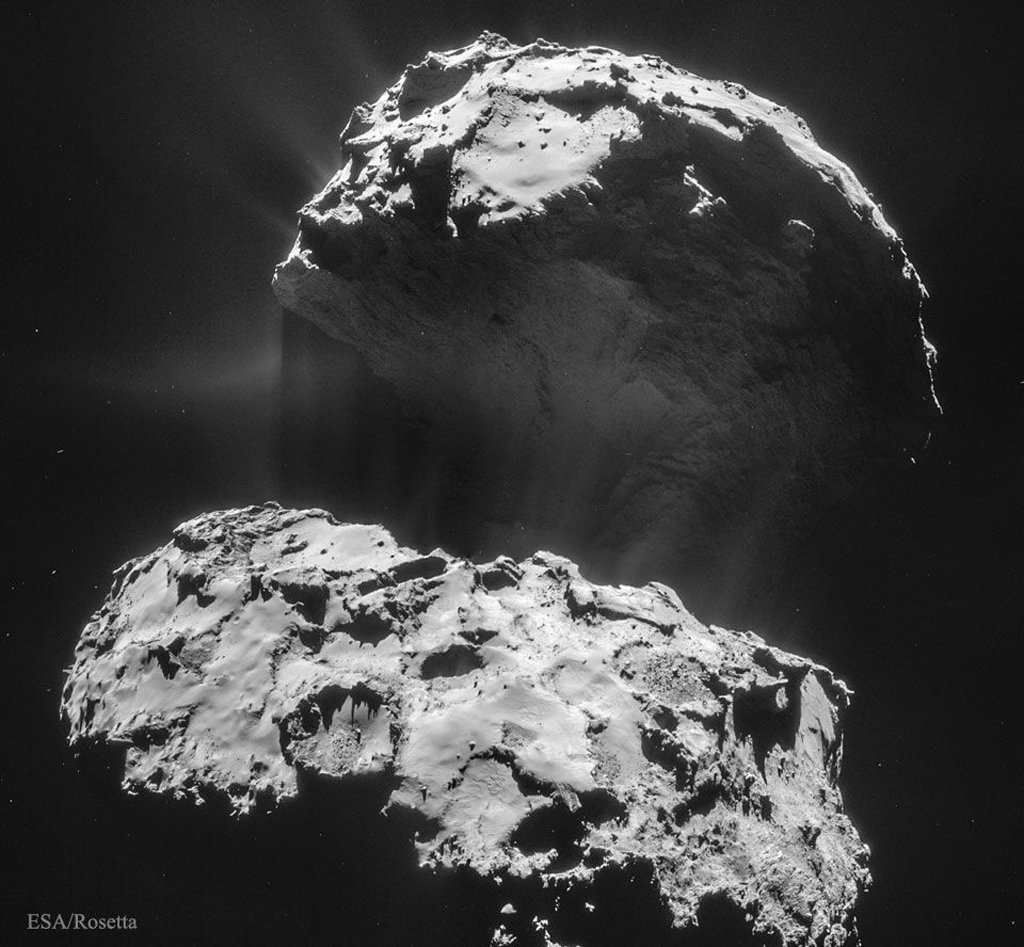 Image of a giant rock in space with a hazy dust cloud around it