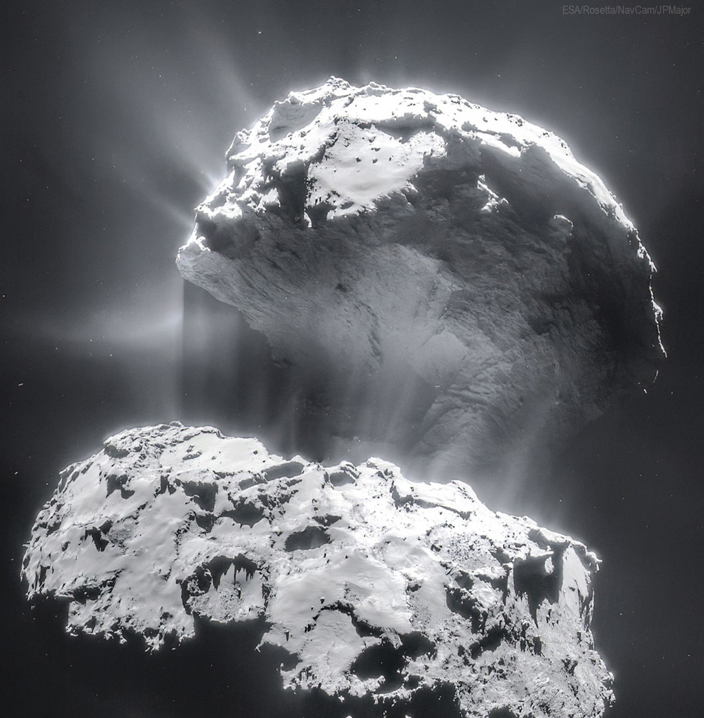 Image of a gray rock with dust around it against a black background