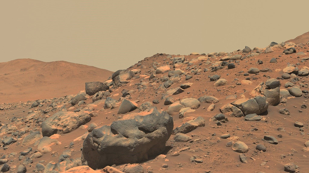 gray boulders on top of the red planet surface