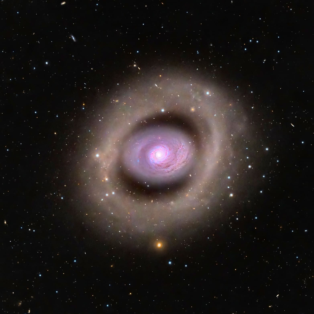 an image of a purple galaxy shaped like a cat's eye agains the dark background of starry space