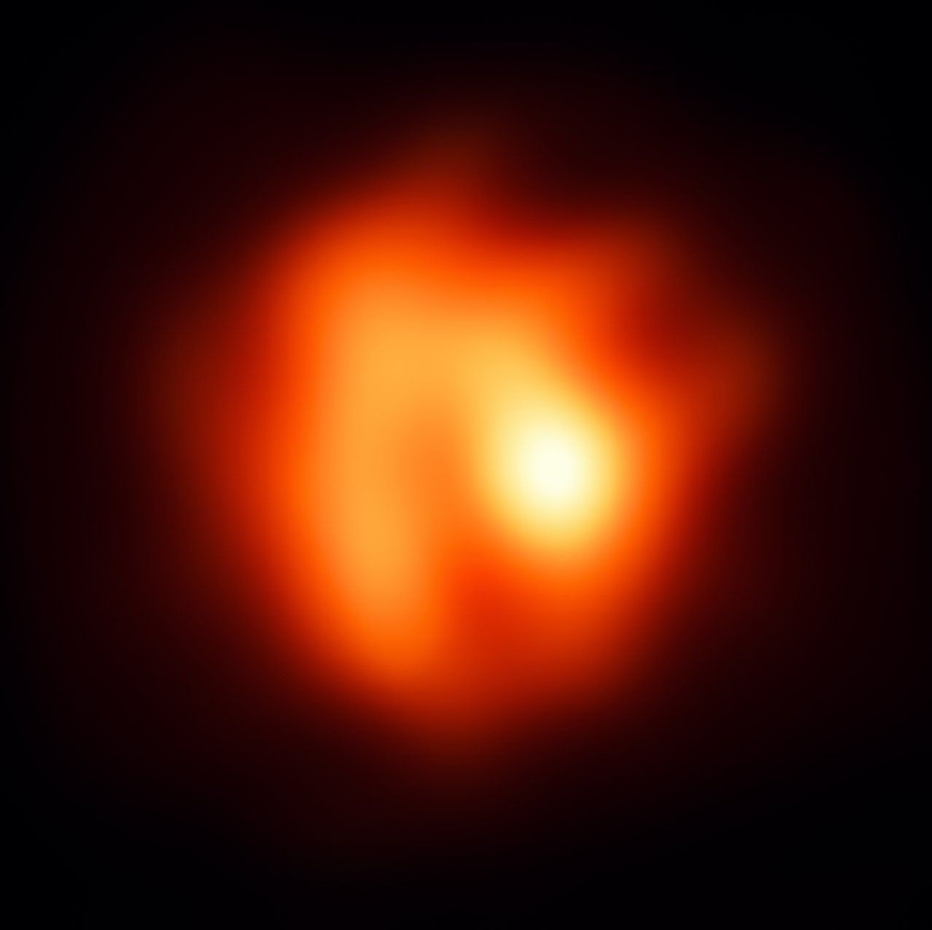 Image of a blurry orange and red figure in outer space