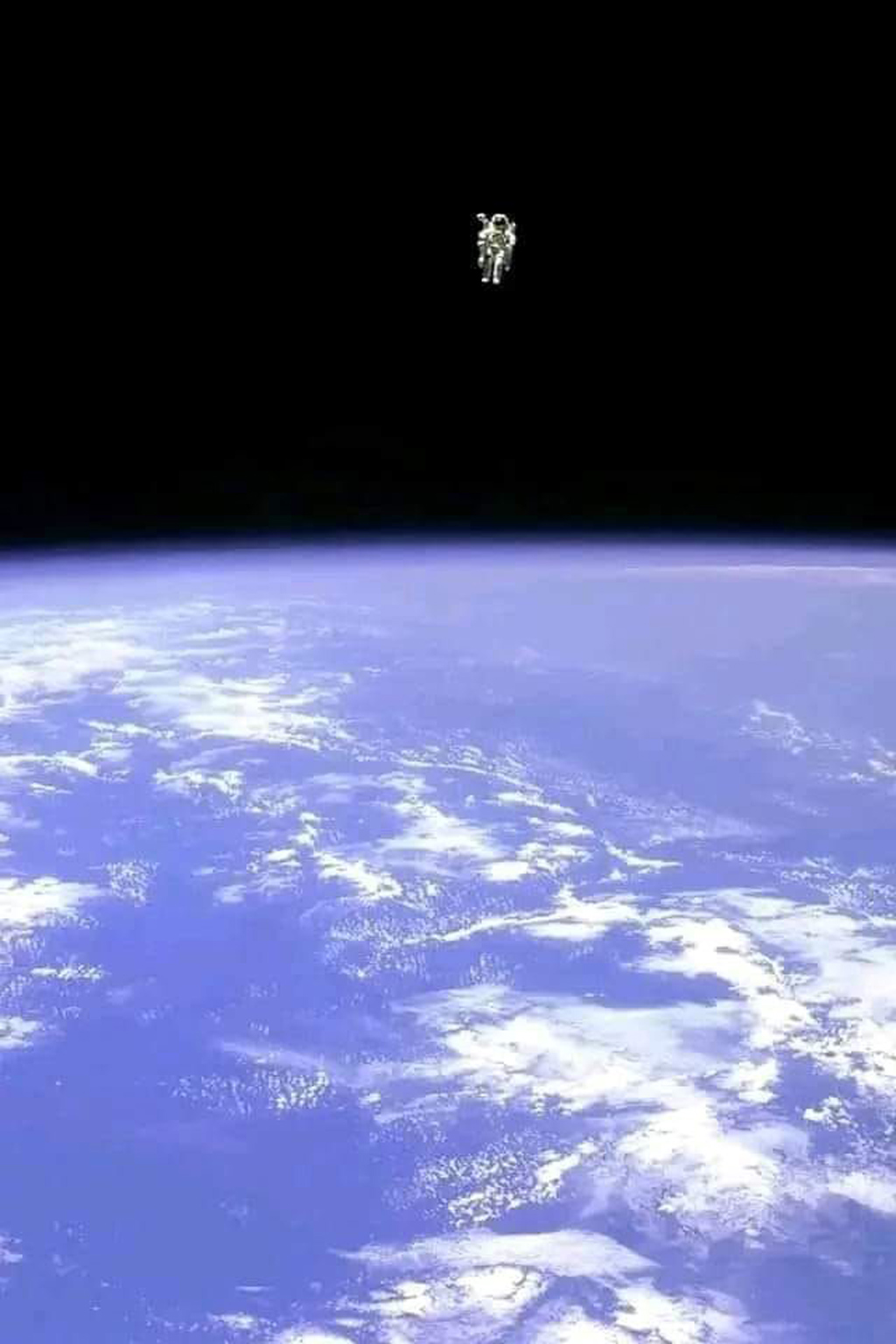 an image of the surface of Earth with an astronaut floating freely above the atmosphere