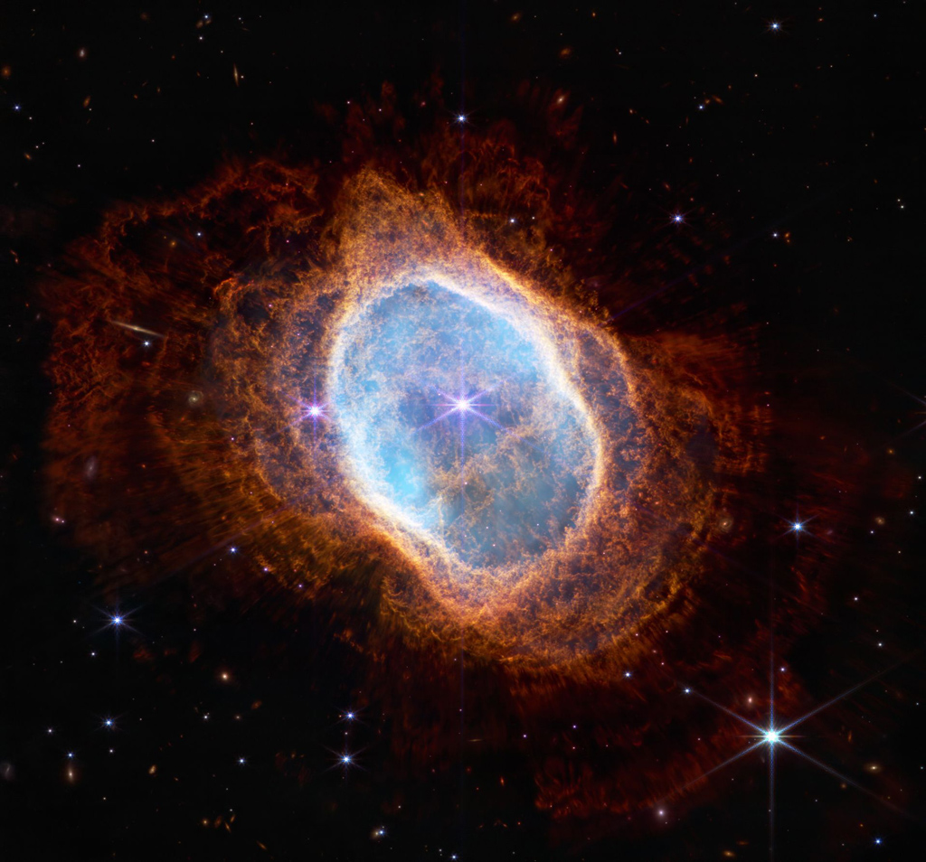 Image of the oranged ringed nebula against a black background.