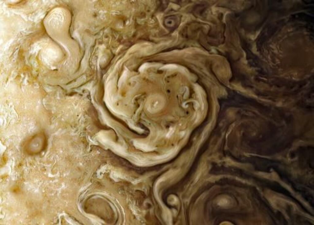 Image of a yellow and beige swirl on the surface of the planet.