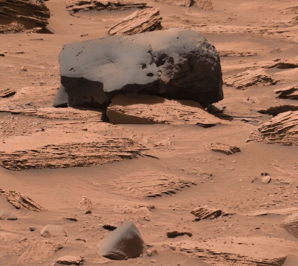 Image of a lone lava block on the red surface of Mars.