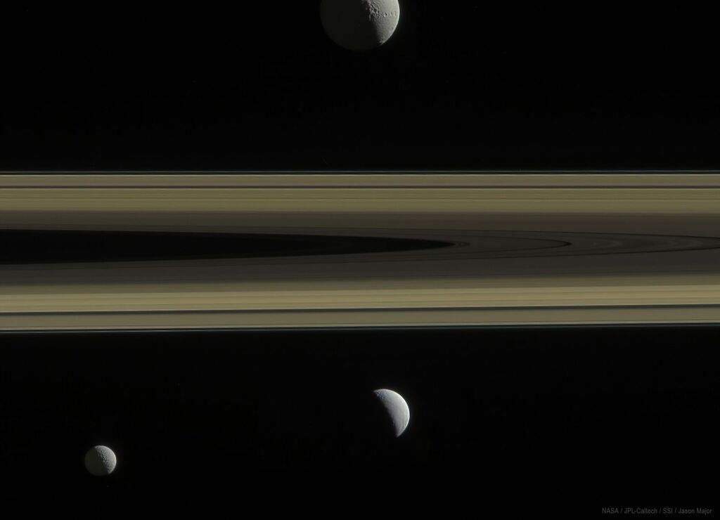 images of Saturn's moons in the distance above and below Saturn's rings.