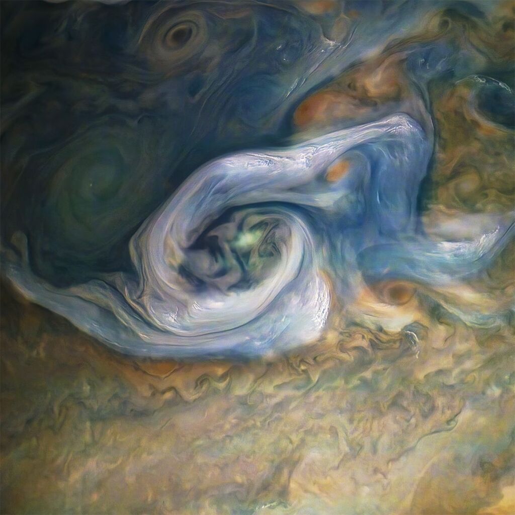 Close up view of the white, cream, and bluish tones and swirls of Jupiter's surface