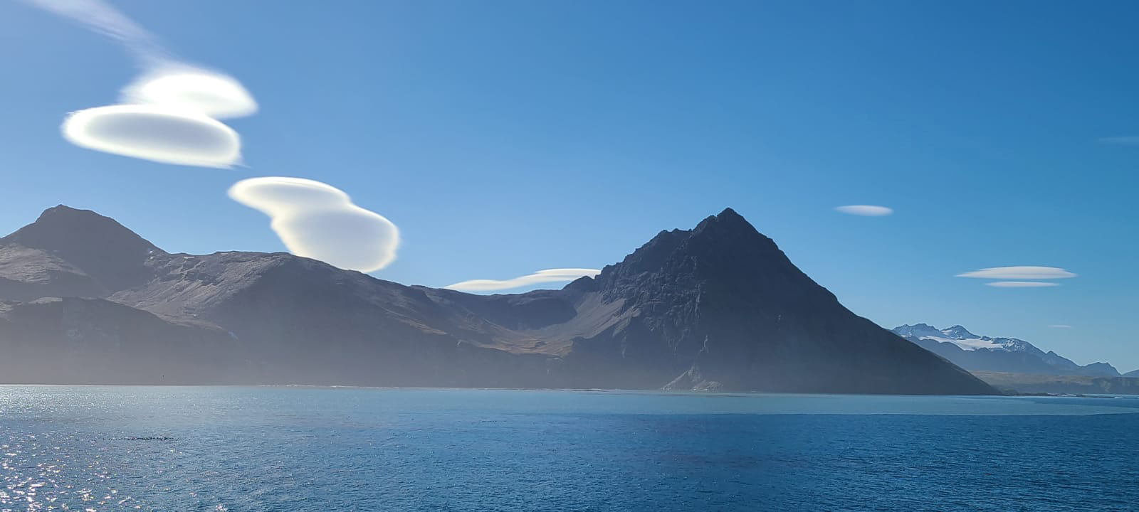 View of the coast with a mountain peak and beautiful full clouds