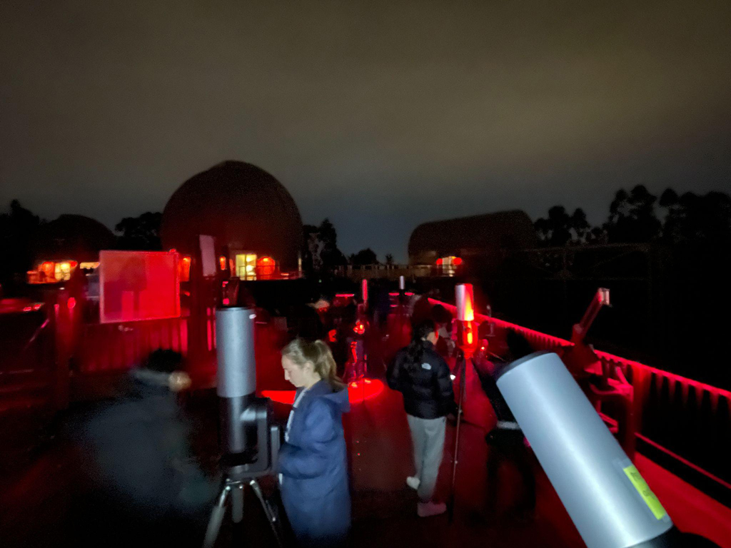 students preparing the telescopes outside on the observation deck