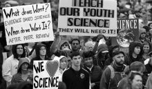 group of protesters holding signs for science