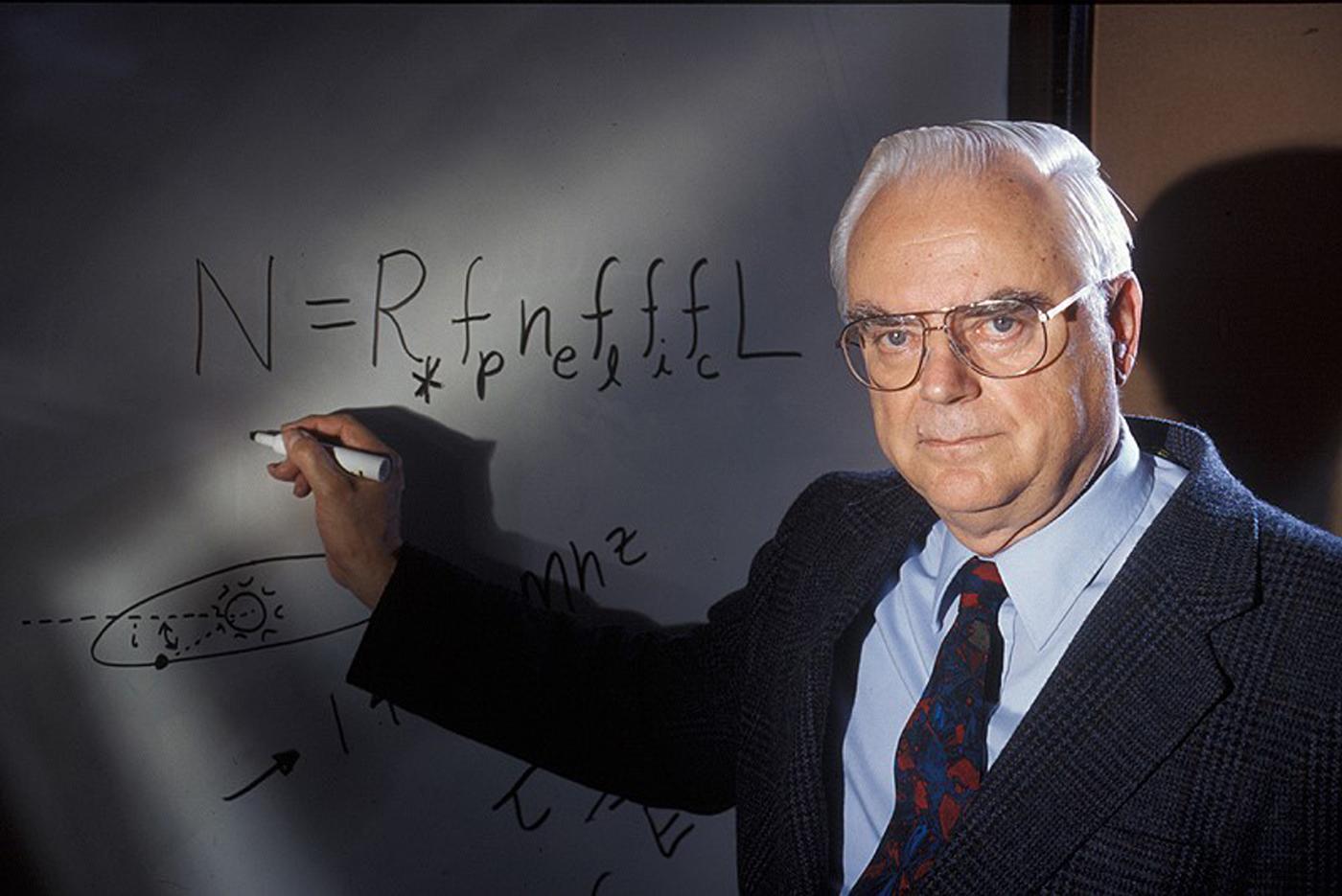 Image of Frank Drake writing down the Drake Equation on a whiteboard
