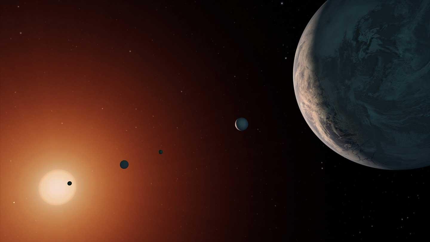 Figure 1: This illustration shows what the TRAPPIST-1 system might look like from a vantage point near planet TRAPPIST-1f