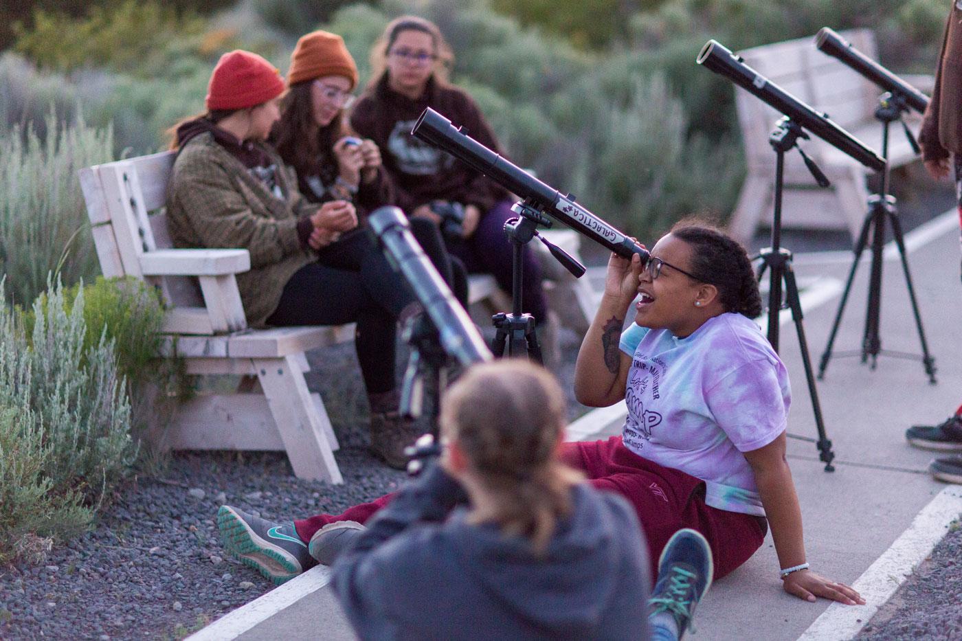 Image of Girl Scouts looking through telescopes