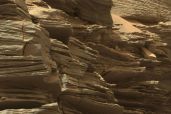 Layered rock formations on Mars. 