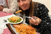 Carolina Bruhl enjoying her meal at a fish restaurant.